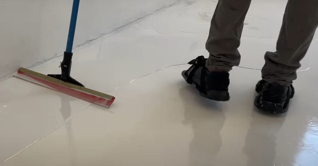 Applying epoxy base coat to a concrete floor