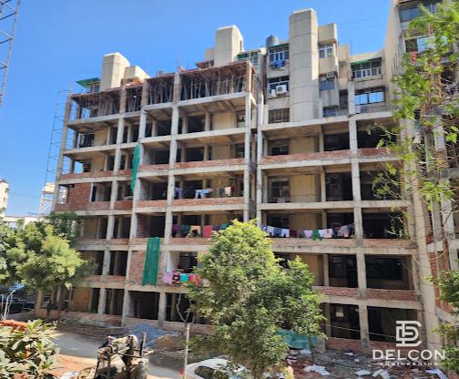 Residential building extension site with construction equipment