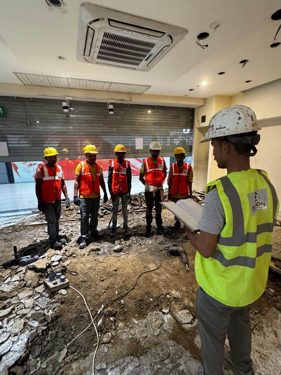 Delcon Engineering team and workers in full PPE gathered for a site safety briefing