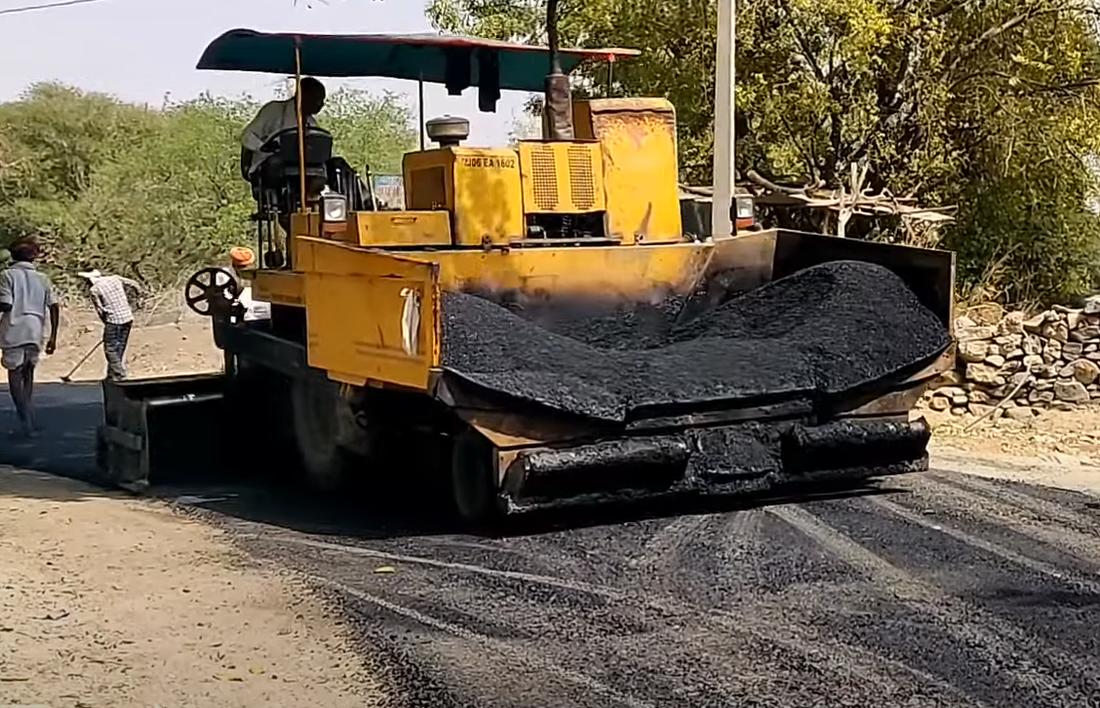 Asphalt paver laying hot-mix bituminous road