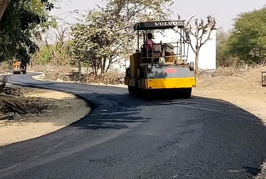 Road roller compacting a freshly paved bituminous road